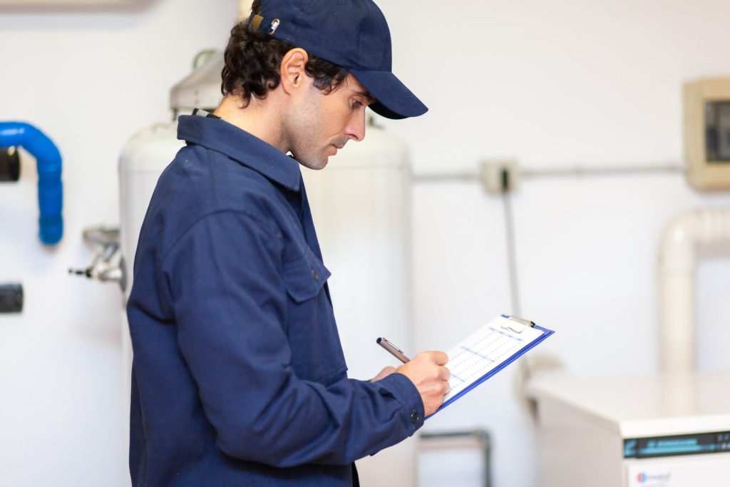 plumber writing on a quotebook