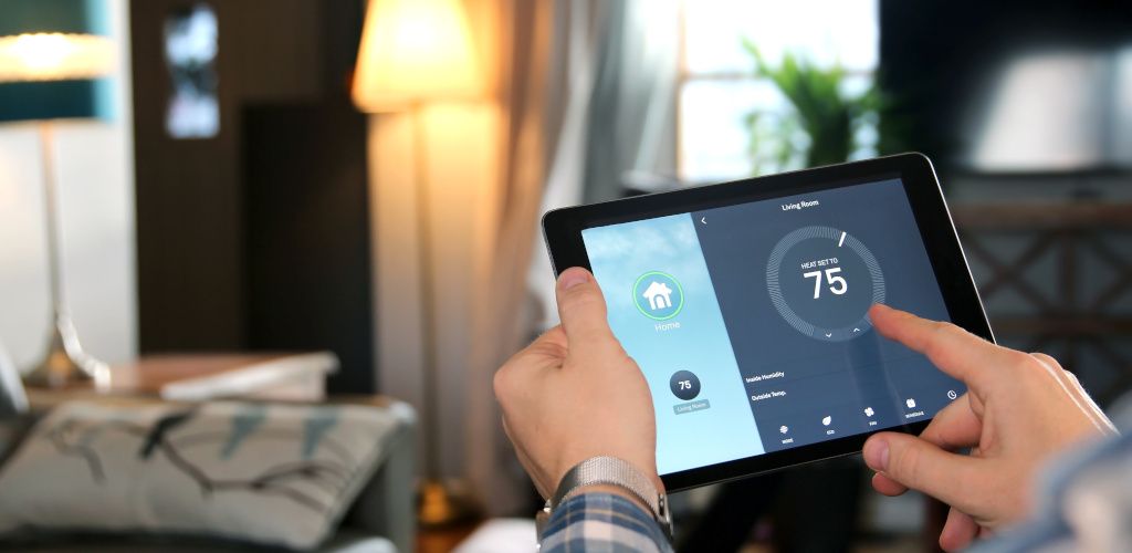 person using tablet app for smart heating